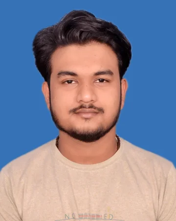A young man in a tan T-shirt posing for a photo.